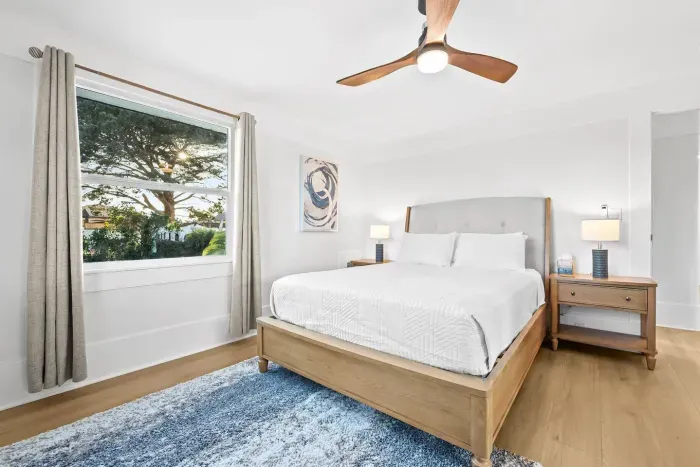 Bright bedroom with a comfy bed and large window for natural light.
