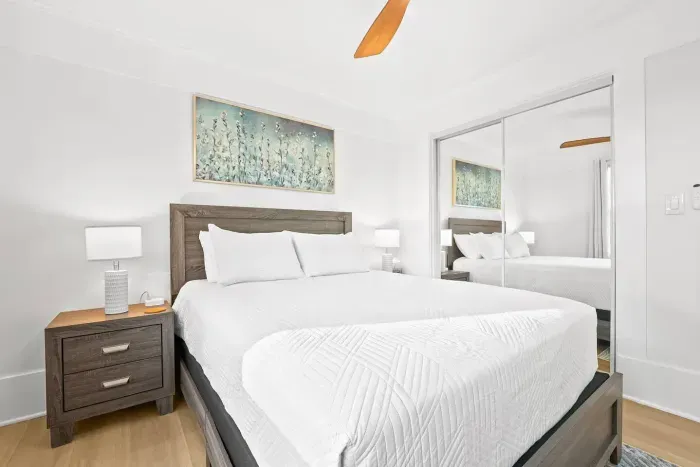 Stylish bedroom with mirrored closet doors.