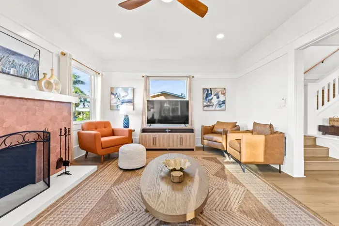 Sunny living room with modern seating and a cozy fireplace.