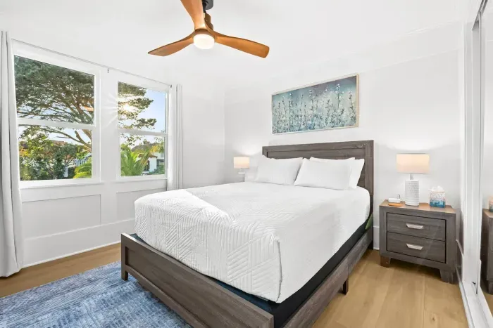 Cozy bedroom with artwork and natural light.