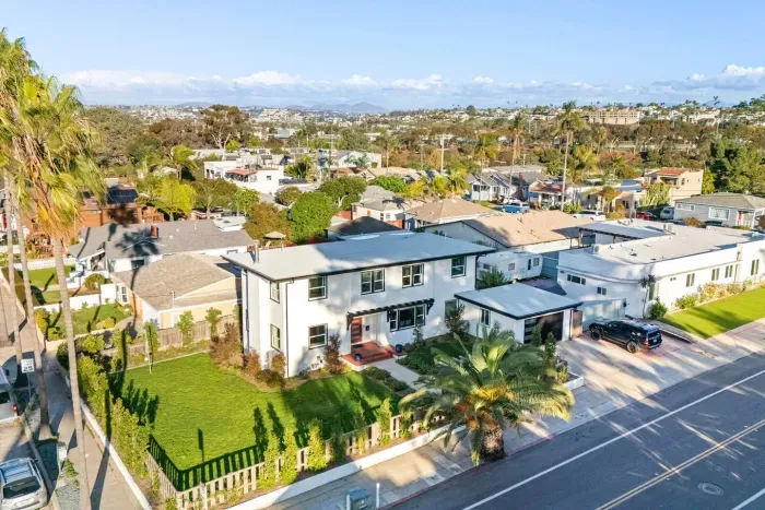 Aerial angle of the home’s yard, landscaping, and corner lot.