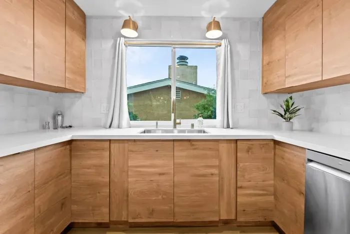 Bright kitchen sink area with warm wood accents.