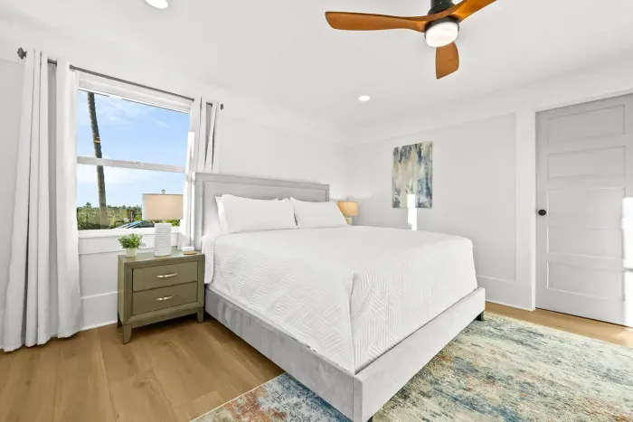 Bright bedroom with king bed and soft tones.