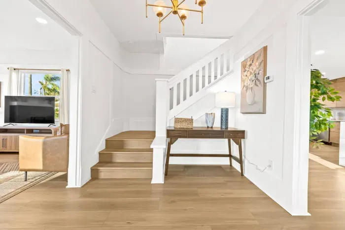 Clean hallway and staircase with warm wood touches.