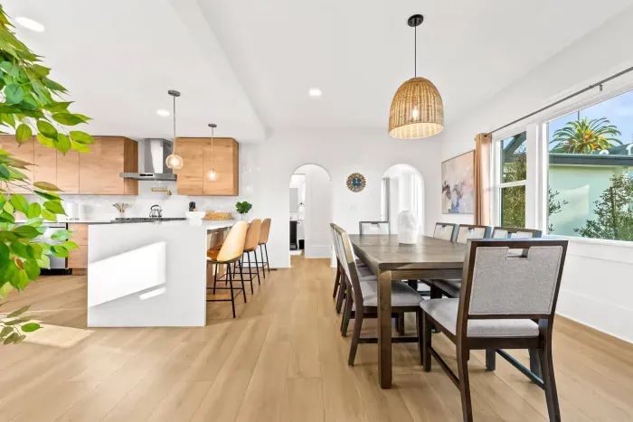 pen dining area with long table and warm pendant lighting.