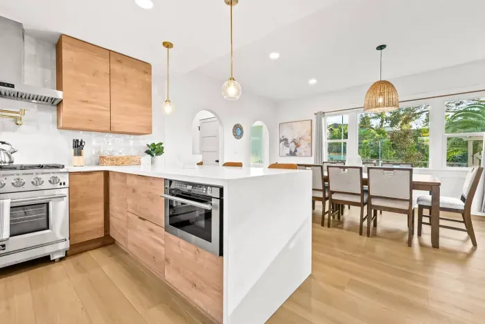 Kitchen island with pendant lights and open layout.
