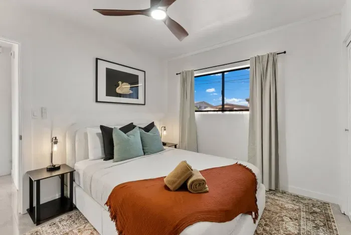 A clean, modern bathroom with fresh finishes and essentials provided.