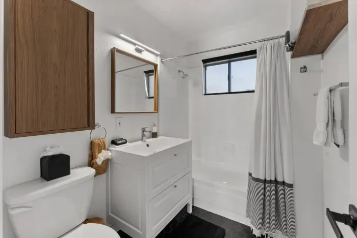A clean, modern bathroom with fresh finishes and essentials provided.
