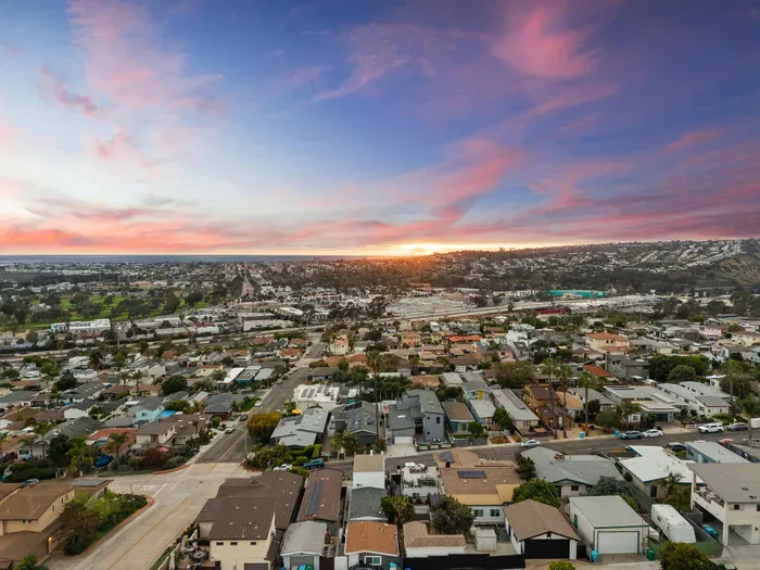 Sunset coastal skyline views over a walkable hillside neighborhood