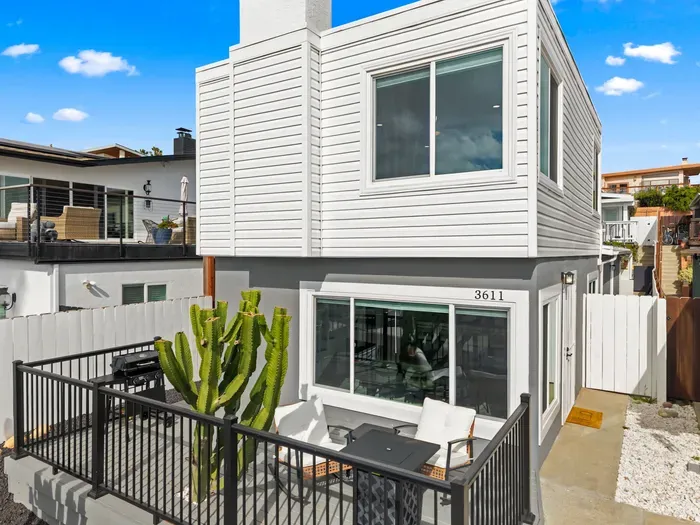 Modern coastal stay with private patio, fire table, and big windows