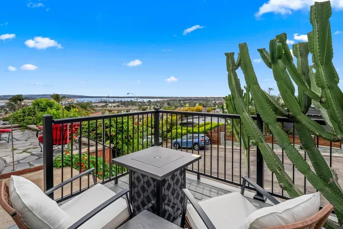 Cozy fire-table patio with bay views and chic desert landscaping.