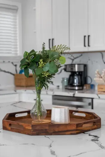 Bright modern kitchen with veined quartz and a ready coffee station