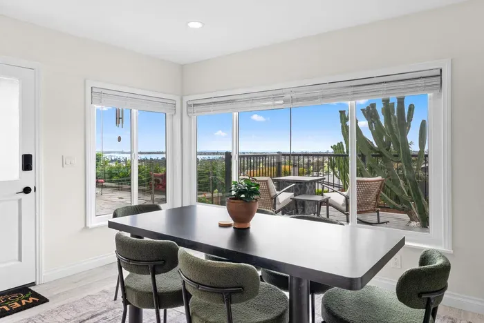 Sunny dining nook with bay-view patio and indoor–outdoor vibes