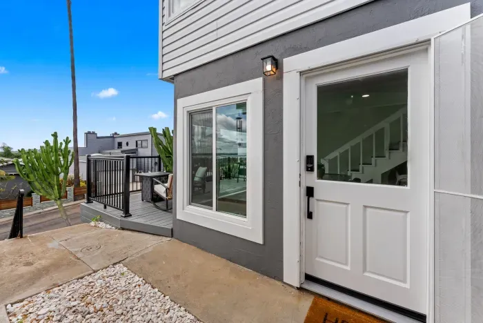 Stylish entry with smart lock, deck lounge, and scenic hillside views