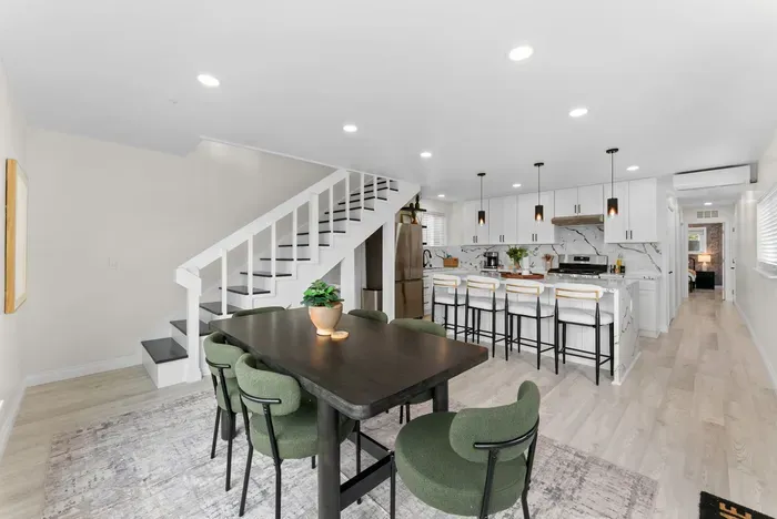Bright open-concept kitchen & dining with island seating for four.