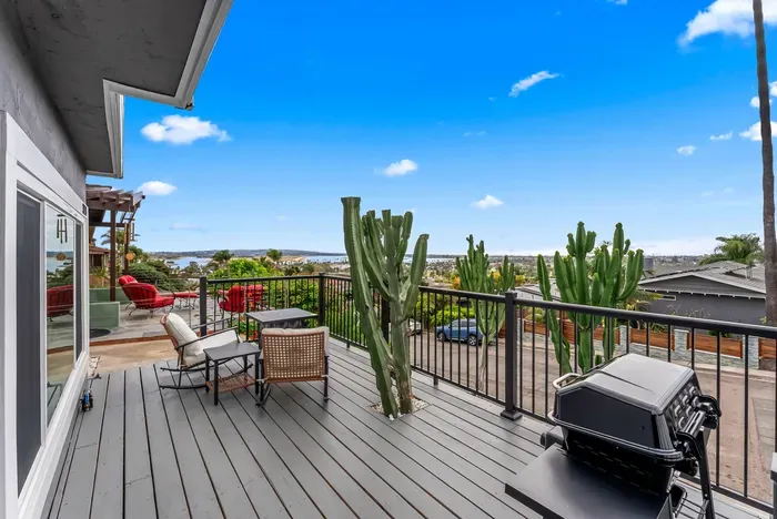 Sunny deck with bay views, lounge seating, and BBQ for al fresco fun