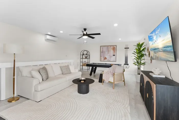 Stylish game lounge with pool table, big TV & comfy seating