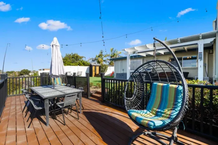 A perfect backyard retreat—relax in the hanging chair, enjoy outdoor dining, and soak up the sunshine