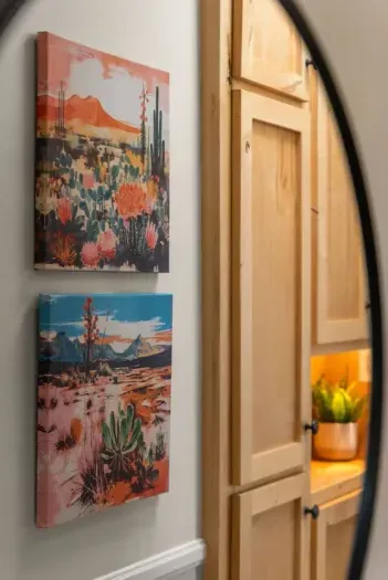 Warm and inviting ambiance with vibrant desert-themed artwork and rustic wooden accents