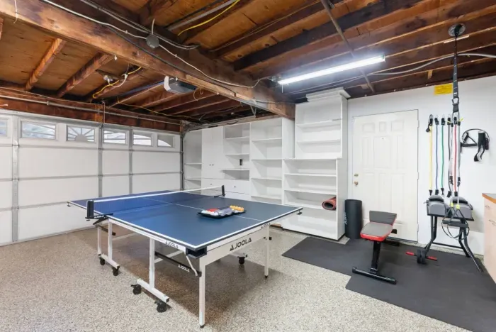 Spacious game and fitness garage with ping pong and workout area!
