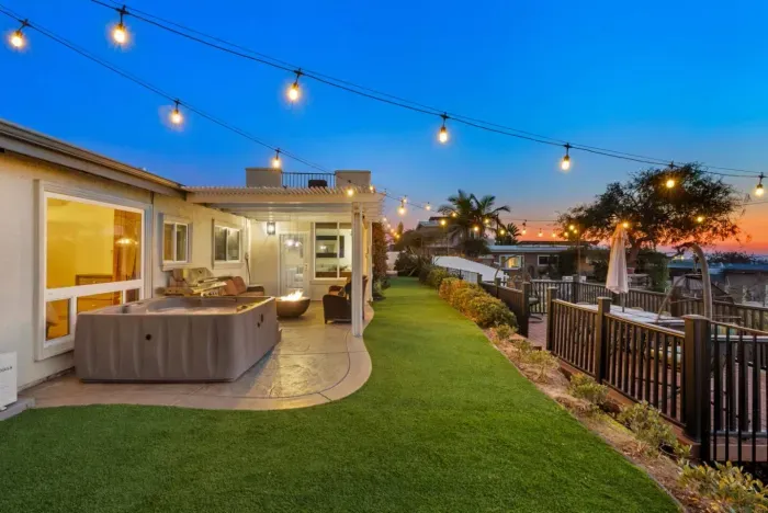 Stunning backyard oasis with hot tub, firepit, and ocean views