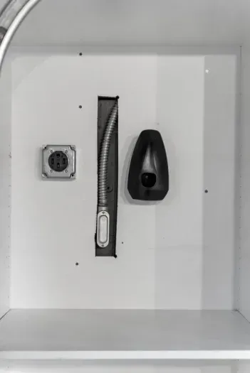 Spacious cabinet with power outlet and storage space.