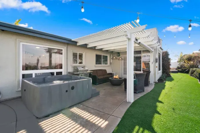 Enjoy a cozy backyard retreat with a fire pit and hot tub.