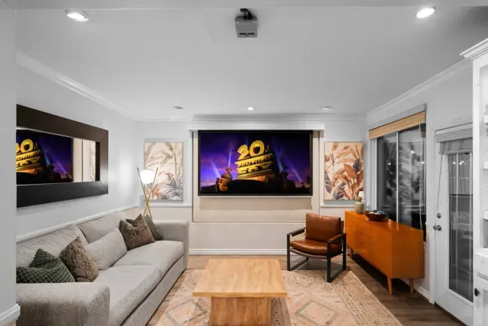 The living room has a projector screen to watch movies or play Nintendo