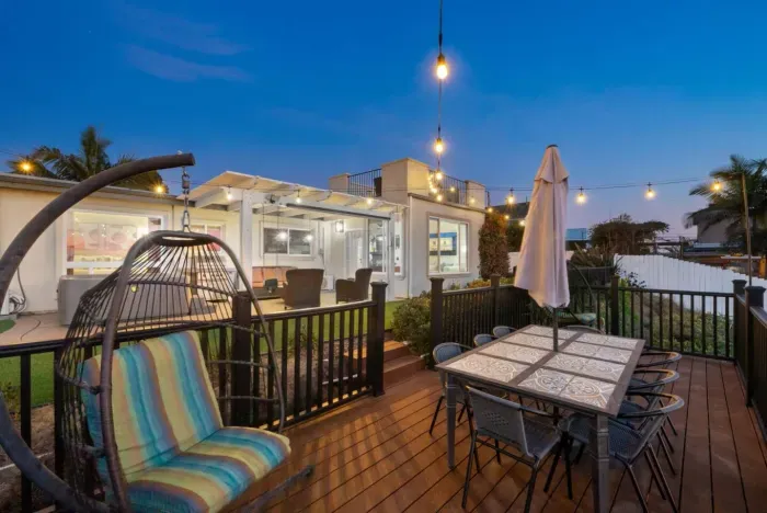 Charming patio with string lights, cozy seating, and a welcoming vibe