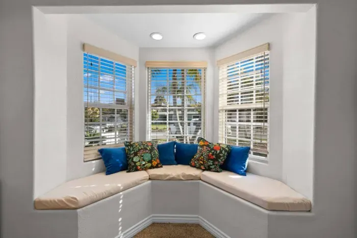 A bright and cozy window nook perfect for relaxing with colorful pillows and lots of natural light.