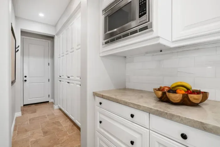 The pantry area includes a microwave and food storage area