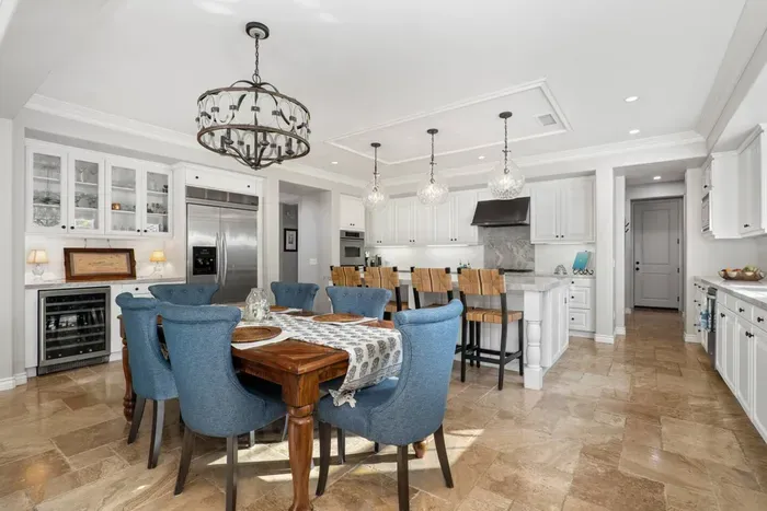 The dining area off of the kitchen seats up to six guests, while you can have four at the bar counter. Enjoy access to a wine fridge, as well as a full chef's kitchen