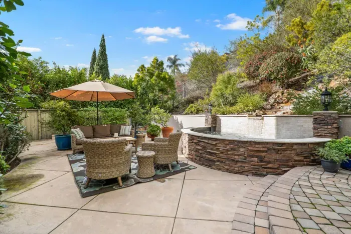 Outdoor patio with a conversation set and a calming water feature