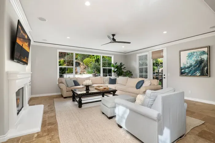 Family room with a ceiling fan and seating for a big group!