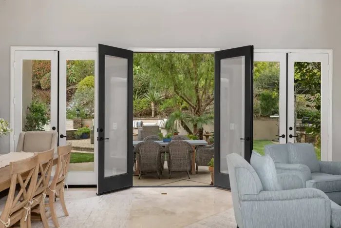 French doors open to the backyard for dining and lounging in the summer sun!
