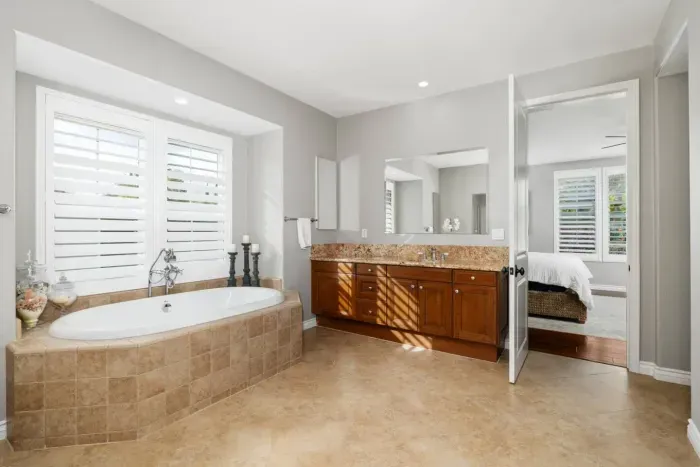 The primary bathroom is attached to Bedroom 1 and includes two vanities, a soaking tub, and shower. (Please note, the closet in here is not accessible. There is an armoire and a set of drawers in the bedroom)
