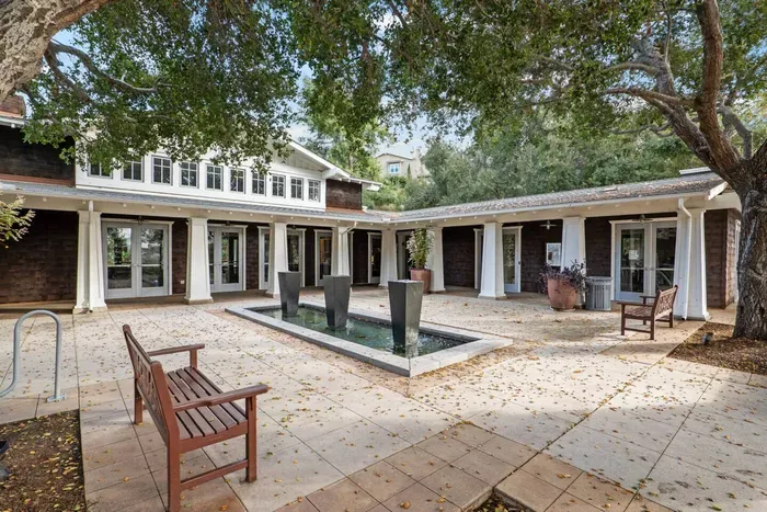 The clubhouse common area has a water feature and bench seating