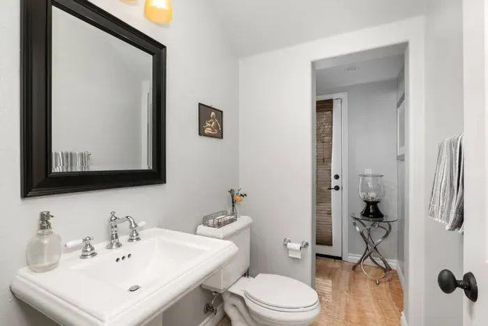 Bathroom 4 is downstairs and is accessible from the backyard as well as the house. It includes a standing shower for rinsing off after beach days!