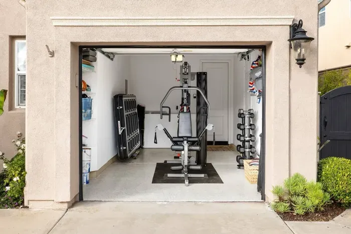 Fully equipped home gym with Bodycraft gym system, free weights and bench, medicine balls, exercise bands and TRX
