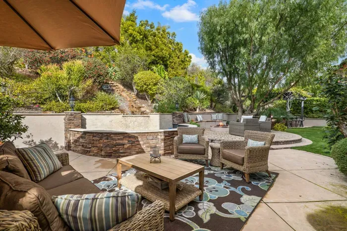Conversation seating area in the backyard near the water feature