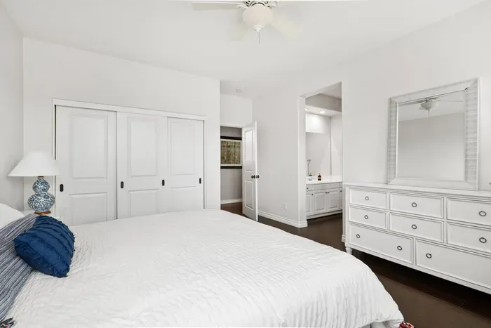 Bedroom 2 features a King bed and dresser. This bedroom has a jack and jill bathroom shared with Bedroom 3, but each room has its own private sink and vanity area.