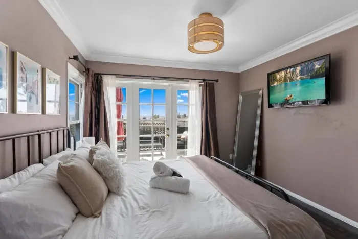 Bay-view bedroom with French doors opening to a private balcony