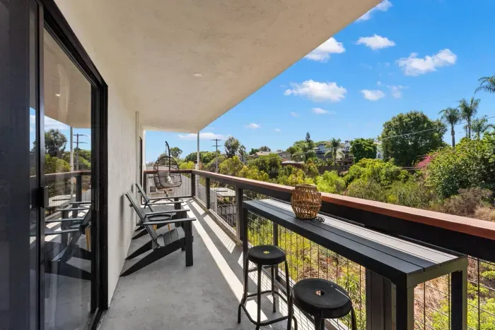 Balcony with Adirondack chairs and canyon views for sunset relaxation.