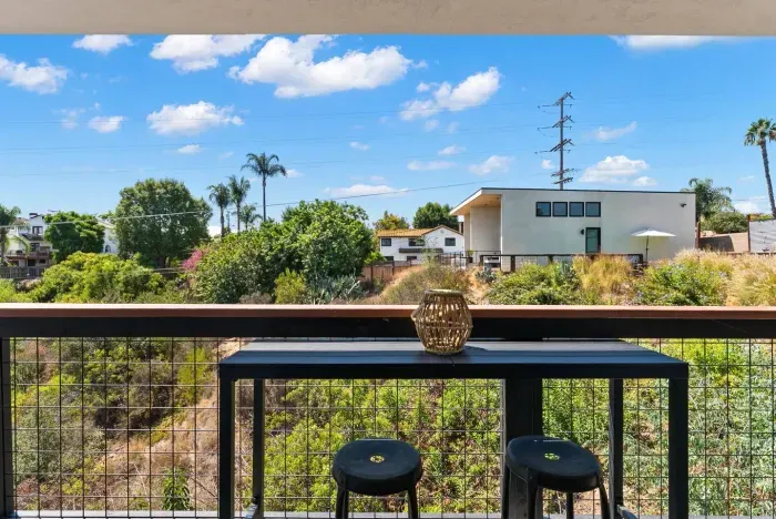 Bar seating on the deck overlooking peaceful greenery.