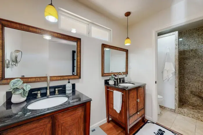 Bathroom with dual sinks, mirrors, and convenient access to the shower.