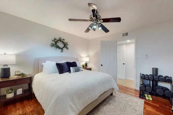 Bedroom equipped with dumbbells for fitness enthusiasts.
