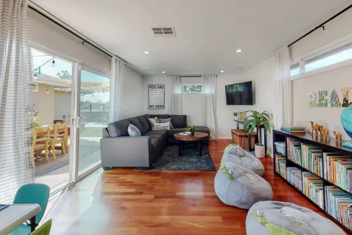 Cozy living room with TV, sofa, and a selection of books for leisurely reading.