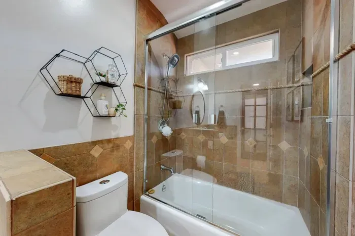 Bathroom featuring both a shower and bathtub for luxurious bathing options.