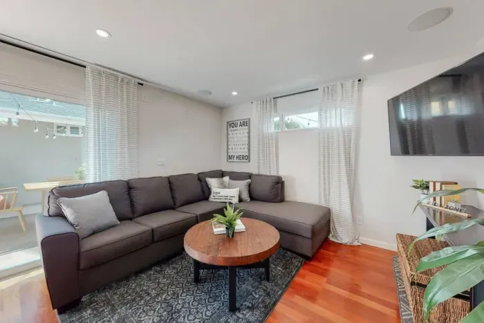 Living room with convenient access to a charming backyard retreat.