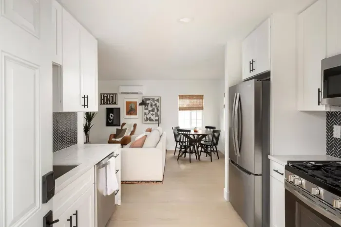 From the kitchen, enjoy an open line of sight to the living and dining areas, making this space feel both social and spacious.